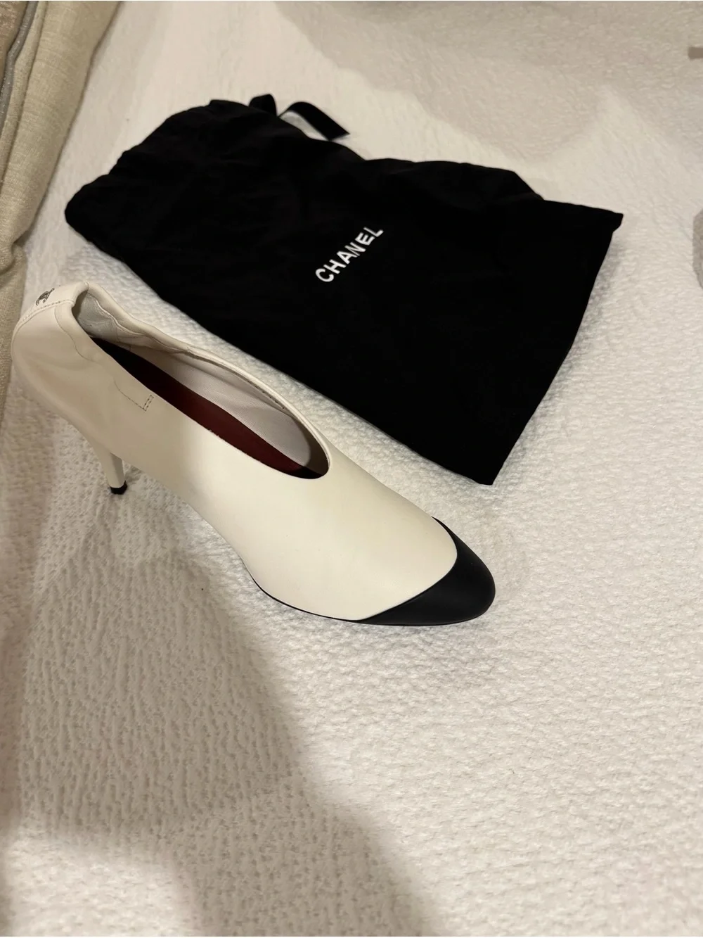 CHANEL Two-Tone White Leather Pumps with Black Cap Toe